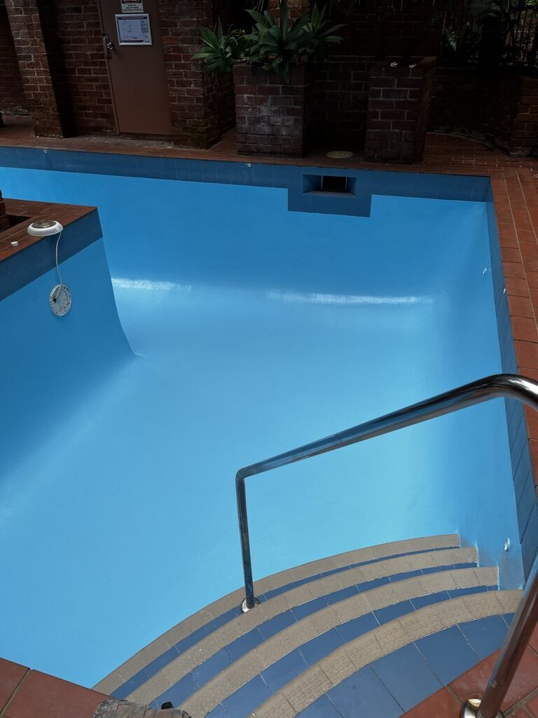 Finished hotel courtyard pool with brick surrounds