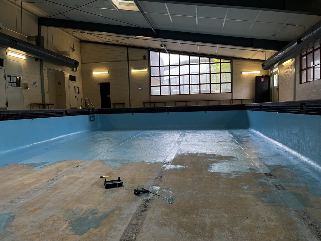 Indoor commercial pool stripped back before resurfacing