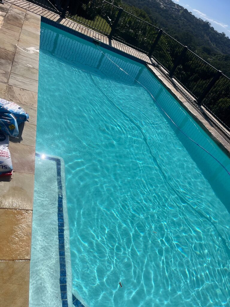 Finished residential pool with vivid turquoise water